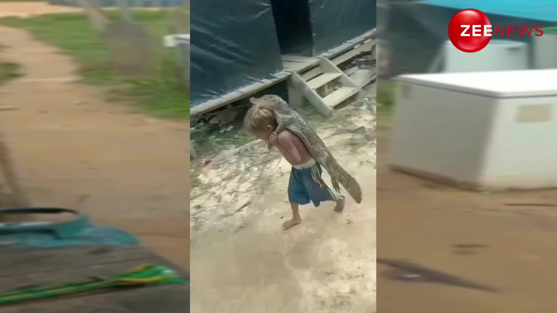 Viral Video: मगरमच्छ को अपनी पीठ पर लेकर घूम रहा है छोटा बच्चा, वीडियो देख सन रह गए लोग
