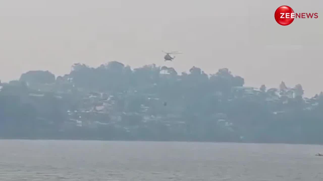 Nainital: धधक रहे जंगलों पर वायुसेना के हेलीकॉप्टर ने बरसाया पानी, बाल्टी से भरते आए नजर